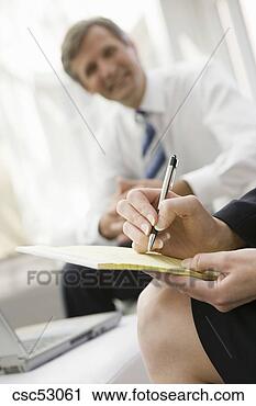 Stock Photography - businesswoman 
writing on notepad. 
fotosearch - search 
stock photos, 
pictures, images, 
and photo clipart