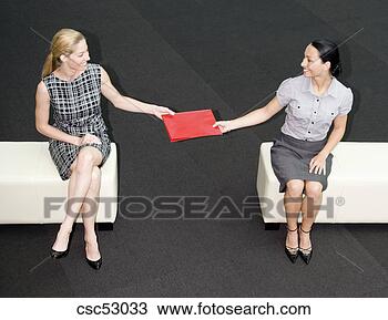 Stock Photo - two businesswomen 
exchanging folder. 
fotosearch - search 
stock photos, 
pictures, images, 
and photo clipart