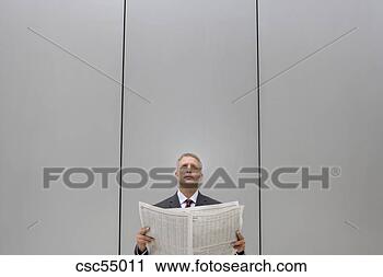 Stock Photography - businessman holding 
newspaper. fotosearch 
- search stock 
photos, pictures, 
images, and photo 
clipart