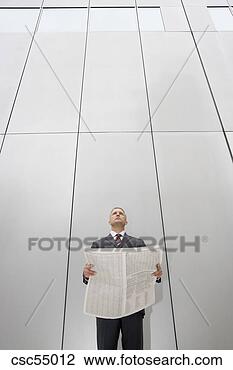 Stock Photo - businessman holding 
newspaper. fotosearch 
- search stock 
photos, pictures, 
images, and photo 
clipart