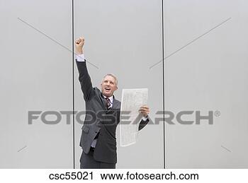 Stock Photography - businessman holding 
newspaper. fotosearch 
- search stock 
photos, pictures, 
images, and photo 
clipart