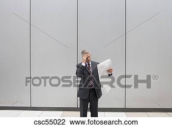 Stock Photo - businessman holding 
newspaper. fotosearch 
- search stock 
photos, pictures, 
images, and photo 
clipart