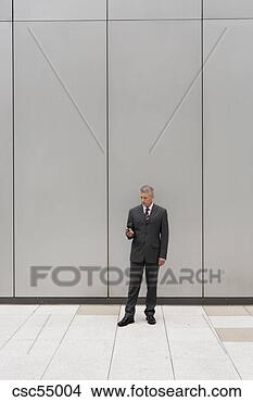 Stock Photo - businessman looking 
at cell phone. 
fotosearch - search 
stock photos, 
pictures, images, 
and photo clipart