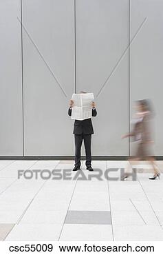 Stock Photograph - businessman reading 
newspaper. fotosearch 
- search stock 
photos, pictures, 
images, and photo 
clipart