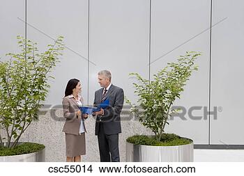 Stock Photo - businesspeople 
discussing paperwork. 
fotosearch - search 
stock photos, 
pictures, images, 
and photo clipart