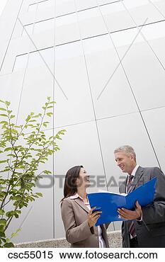 Stock Image - businesspeople 
discussing paperwork. 
fotosearch - search 
stock photos, 
pictures, images, 
and photo clipart