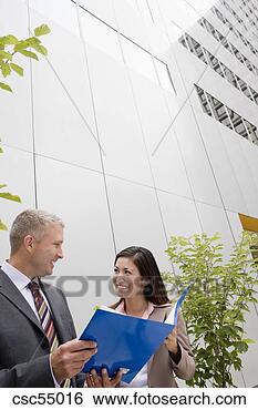 Stock Photo - businesspeople 
discussing paperwork. 
fotosearch - search 
stock photos, 
pictures, images, 
and photo clipart