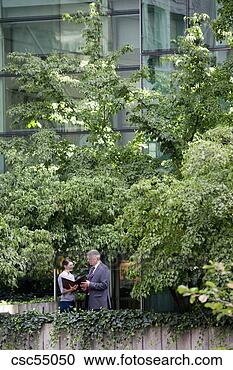 Stock Photography - businesspeople 
discussing paperwork. 
fotosearch - search 
stock photos, 
pictures, images, 
and photo clipart