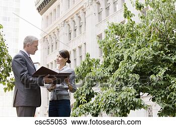 Stock Photo - businesspeople 
discussing paperwork. 
fotosearch - search 
stock photos, 
pictures, images, 
and photo clipart