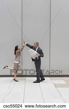 Stock Photo - businesspeople 
high fiving. fotosearch 
- search stock 
photos, pictures, 
images, and photo 
clipart