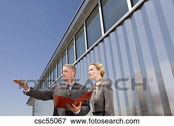Picture - businesspeople 
holding paperwork. 
fotosearch - search 
stock photos, 
pictures, images, 
and photo clipart