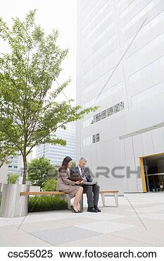 Stock Image - businesspeople 
looking at laptop. 
fotosearch - search 
stock photos, 
pictures, images, 
and photo clipart