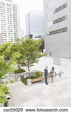 Stock Photograph - businesspeople 
standing next 
to bench. fotosearch 
- search stock 
photos, pictures, 
images, and photo 
clipart