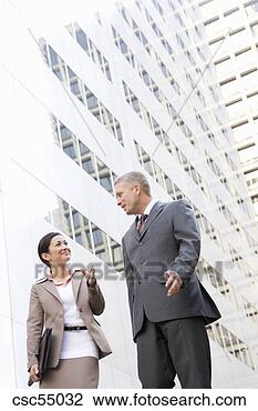 Stock Photo - businesspeople 
talking next to 
building. fotosearch 
- search stock 
photos, pictures, 
images, and photo 
clipart
