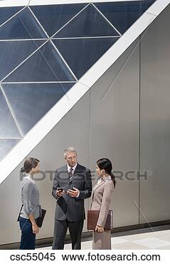 Stock Image - businesspeople 
talking next to 
building. fotosearch 
- search stock 
photos, pictures, 
images, and photo 
clipart