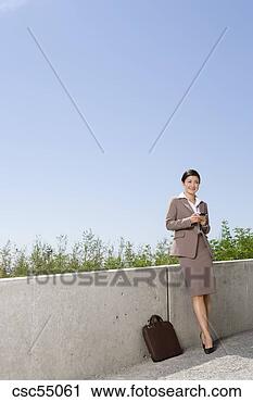 Stock Photography - businesswoman 
holding cell phone. 
fotosearch - search 
stock photos, 
pictures, images, 
and photo clipart