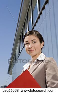 Stock Photo - businesswoman 
holding paperwork. 
fotosearch - search 
stock photos, 
pictures, images, 
and photo clipart