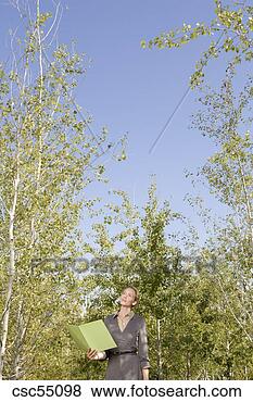 Stock Photo - businesswoman 
holding paperwork. 
fotosearch - search 
stock photos, 
pictures, images, 
and photo clipart