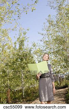 Stock Photograph - businesswoman 
holding paperwork. 
fotosearch - search 
stock photos, 
pictures, images, 
and photo clipart