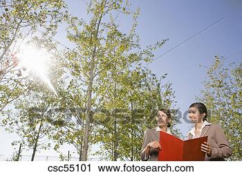 Stock Photography - businesswomen 
holding paperwork. 
fotosearch - search 
stock photos, 
pictures, images, 
and photo clipart