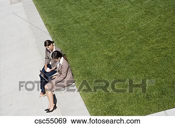 Stock Photograph - businesswomen 
looking at laptop. 
fotosearch - search 
stock photos, 
pictures, images, 
and photo clipart