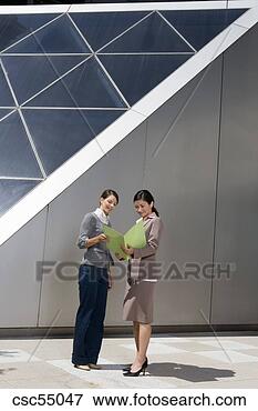 Picture - businesswomen 
looking at paperwork. 
fotosearch - search 
stock photos, 
pictures, images, 
and photo clipart