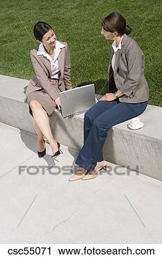 Stock Photography - businesswomen 
sitting on wall. 
fotosearch - search 
stock photos, 
pictures, images, 
and photo clipart
