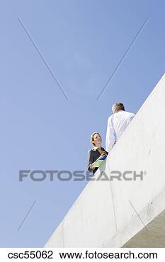 Stock Photo - low angle view 
of businesspeople. 
fotosearch - search 
stock photos, 
pictures, images, 
and photo clipart