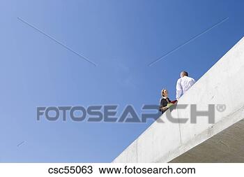Stock Photo - low angle view 
of businesspeople. 
fotosearch - search 
stock photos, 
pictures, images, 
and photo clipart