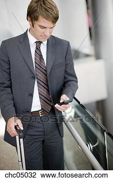 Stock Photo - businessman looking 
at cell phone. 
fotosearch - search 
stock photos, 
pictures, images, 
and photo clipart