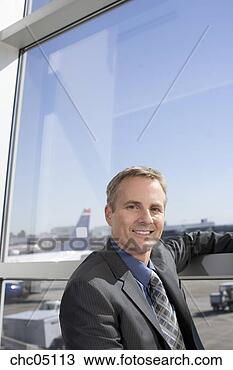 Stock Photo - businessman next 
to airport window. 
fotosearch - search 
stock photos, 
pictures, images, 
and photo clipart