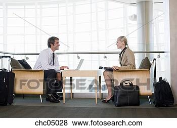 Stock Photo - businesspeople 
sitting next to 
suitcases. fotosearch 
- search stock 
photos, pictures, 
images, and photo 
clipart