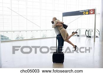 Stock Photo - couple hugging 
in airport. fotosearch 
- search stock 
photos, pictures, 
images, and photo 
clipart
