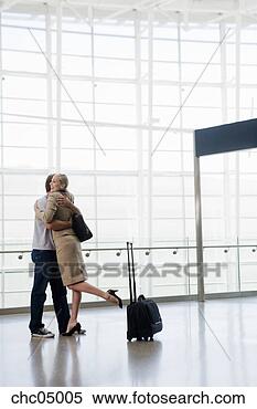 Stock Image - couple hugging 
next to suitcase. 
fotosearch - search 
stock photos, 
pictures, images, 
and photo clipart