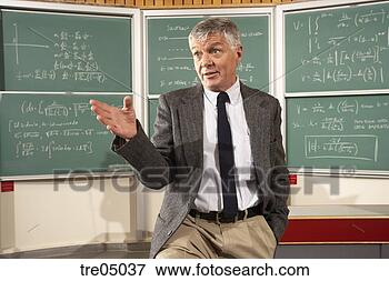 Picture - teacher in front 
of blackboard. 
fotosearch - search 
stock photos, 
pictures, images, 
and photo clipart