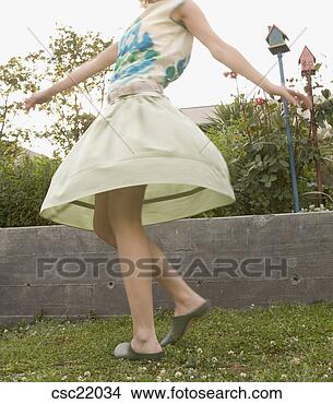 Stock Photo - woman spinning 
in garden. fotosearch 
- search stock 
photos, pictures, 
images, and photo 
clipart