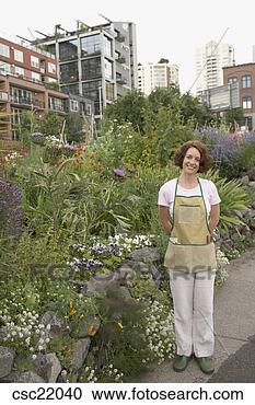 Stock Photography - woman standing 
in urban garden. 
fotosearch - search 
stock photos, 
pictures, images, 
and photo clipart
