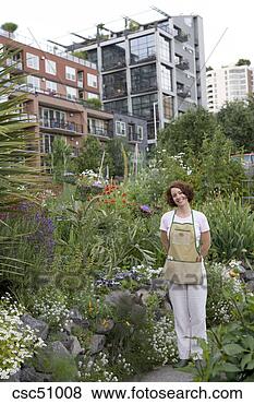 Stock Photo - woman standing 
in urban garden. 
fotosearch - search 
stock photos, 
pictures, images, 
and photo clipart