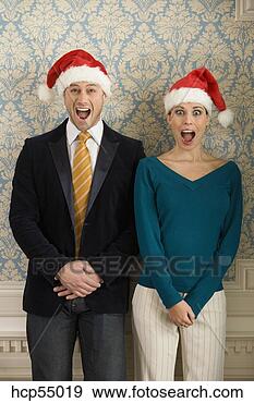Stock Photograph - couple in santa 
hats. fotosearch 
- search stock 
photos, pictures, 
images, and photo 
clipart