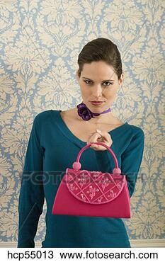 Stock Photo - woman holding 
out purse. fotosearch 
- search stock 
photos, pictures, 
images, and photo 
clipart