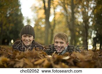Stock Photo - two brothers smiling 
in park. fotosearch 
- search stock 
photos, pictures, 
images, and photo 
clipart