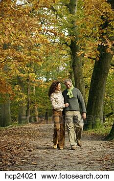 Stock Photography - couple walking 
in the woods. 
fotosearch - search 
stock photos, 
pictures, images, 
and photo clipart