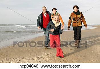 Stock Photo - family running 
on beach. fotosearch 
- search stock 
photos, pictures, 
images, and photo 
clipart