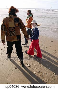 Stock Photo - family walking 
on beach. fotosearch 
- search stock 
photos, pictures, 
images, and photo 
clipart