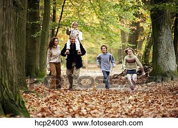 Stock Photo - family walking 
in the woods. 
fotosearch - search 
stock photos, 
pictures, images, 
and photo clipart