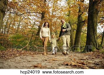 Stock Photograph - family walking 
in the woods. 
fotosearch - search 
stock photos, 
pictures, images, 
and photo clipart