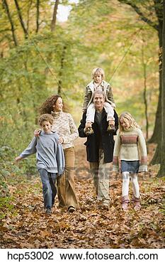 Stock Photo - family walking 
in the woods. 
fotosearch - search 
stock photos, 
pictures, images, 
and photo clipart