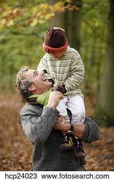 Stock Photo - father carrying 
child on shoulders 
in the woods. 
fotosearch - search 
stock photos, 
pictures, images, 
and photo clipart