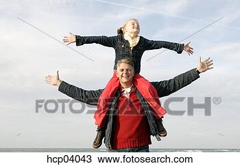 Stock Photo - father carrying 
daughter on shoulders. 
fotosearch - search 
stock photos, 
pictures, images, 
and photo clipart