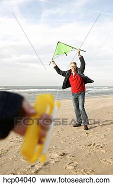 Stock Photography - father and daughter 
flying kite on 
beach. fotosearch 
- search stock 
photos, pictures, 
images, and photo 
clipart